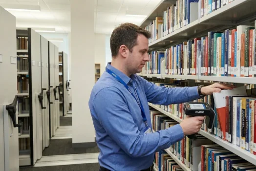 Library Staff scanning the inventory of books which are tagged with the RFID tags using the smart rfid based library management system